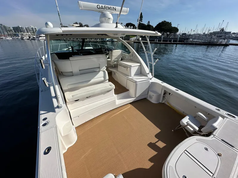 Slide: The Image of 2013 Tiara Yachts 3900 Open boat with spacious deck and seating, docked in marina. - 43