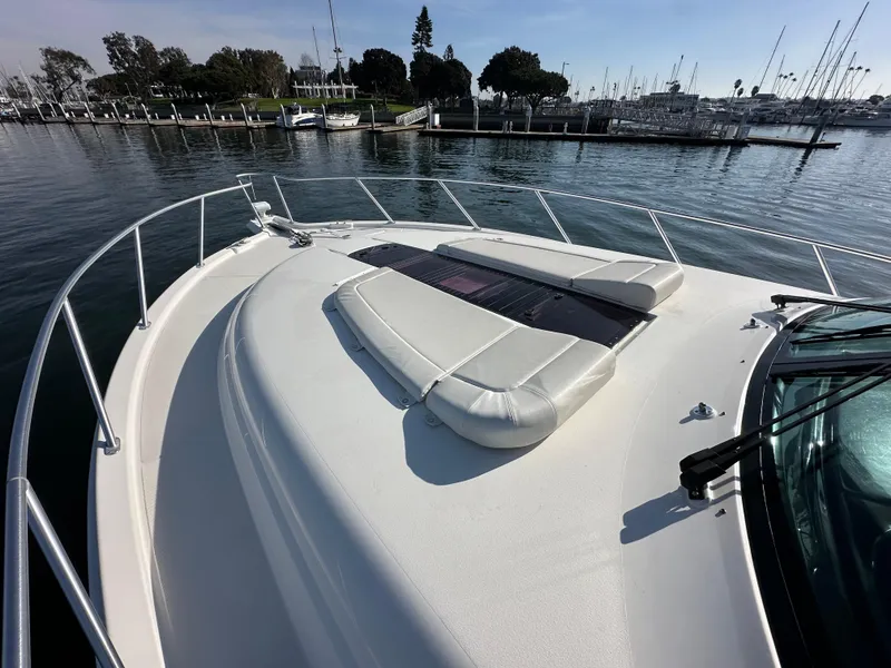Slide: The Image of 2013 Tiara Yachts 3900 Open on calm water, featuring spacious deck and sunbathing area. - 44