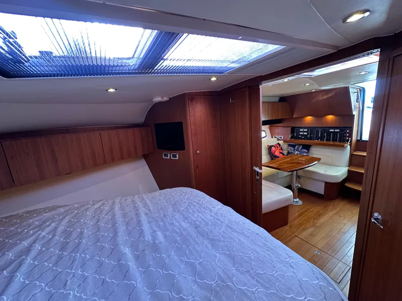 Slide: The Image of 2013 Tiara Yachts 3900 Open interior with cozy bedroom and dining area. - 49