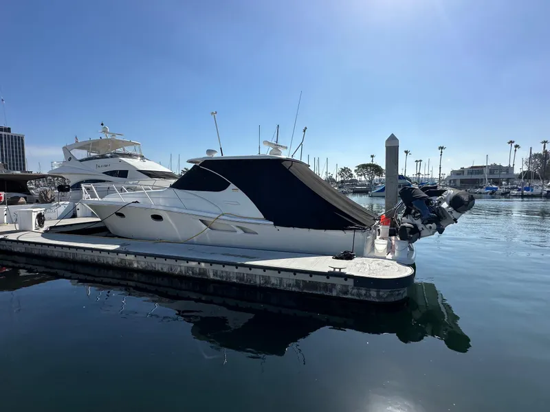 Slide: The Image of 2013 Tiara Yachts 3900 Open docked in a marina under clear blue skies. - 6