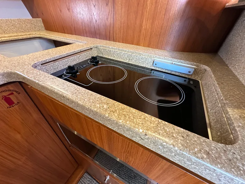 Slide: The Image of Modern kitchen area in 2013 Tiara Yachts 3900 Open with electric stovetop. - 7