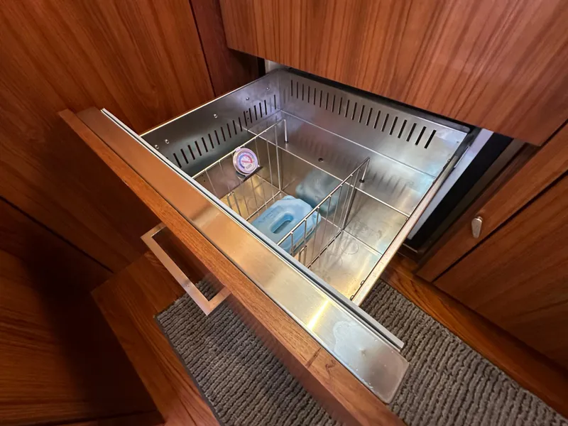 Slide: The Image of Open drawer in 2013 Tiara Yachts 3900 Open, featuring stainless steel interior and wooden finish. - 9