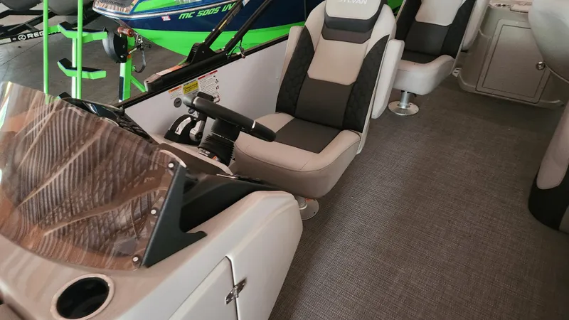 Slide: The Image of Sylvan L3 2026: Modern helm with cushioned seat and gray carpet flooring. - 15