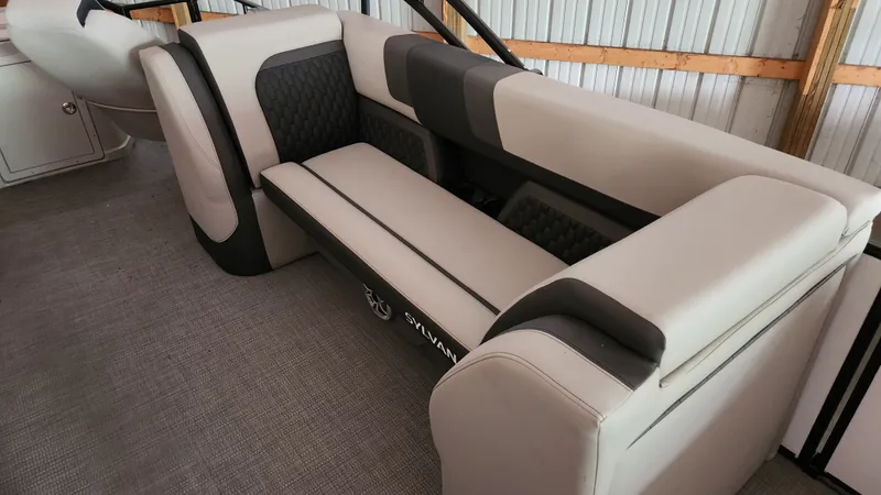 Slide: The Image of The image shows the seating of a 2026 Sylvan L3 boat with cushioned, two-tone upholstery. - 14