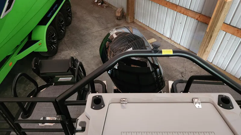 Slide: The Image of A 2026 Sylvan L3 in a storage facility, next to a green boat trailer. - 26