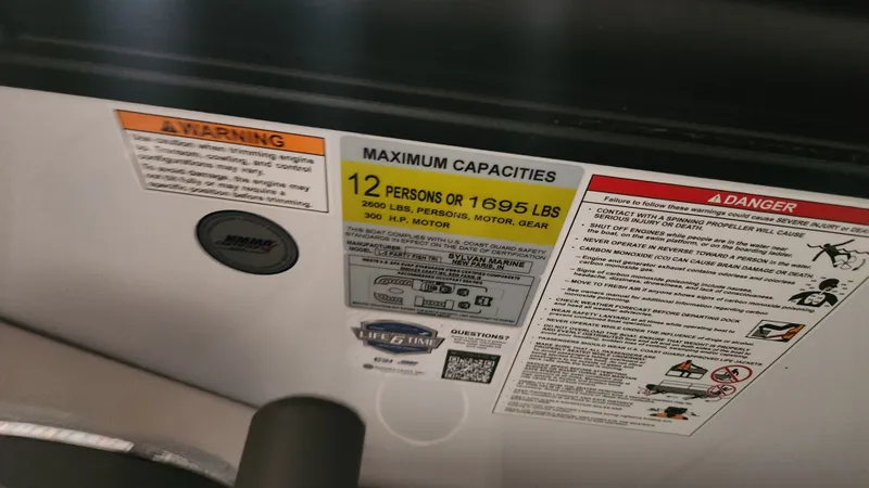 Slide: The Image of Safety and capacity labels on a boat, accommodating 12 persons or 1695 pounds. - 20