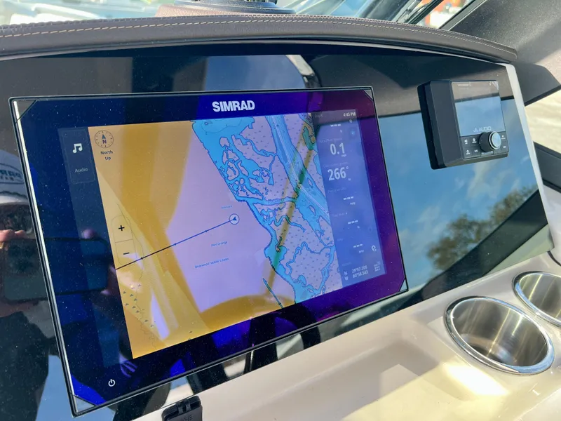 Slide: The Image of Simrad navigation display on 2025 Boston Whaler 240 Vantage boat dashboard. - 13