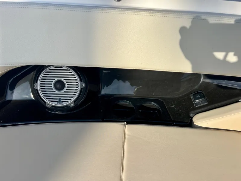 Slide: The Image of Interior detail of 2025 Boston Whaler 240 Vantage boat, featuring speaker and beige upholstery. - 22