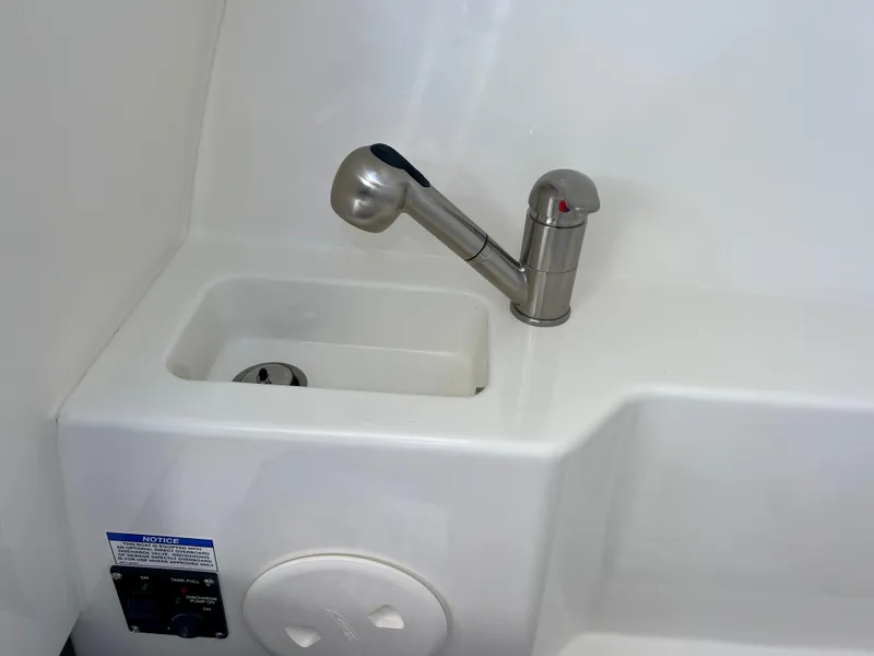 Slide: The Image of Stainless steel faucet on 2025 Boston Whaler 240 Vantage boat sink. - 28
