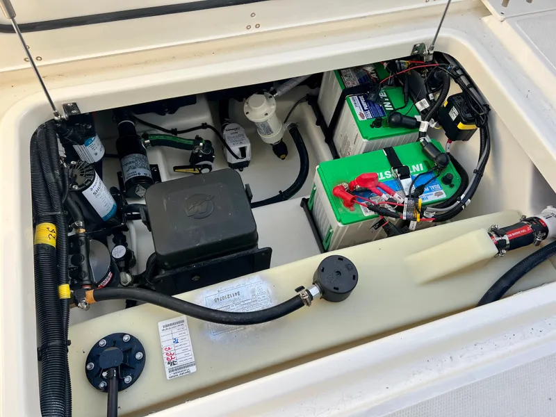 Slide: The Image of 2025 Boston Whaler 240 Vantage engine compartment with batteries and wiring. - 30
