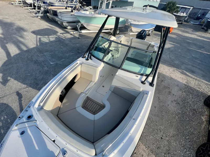 Slide: The Image of 2025 Boston Whaler 240 Vantage boat with spacious seating, docked outdoors. - 32