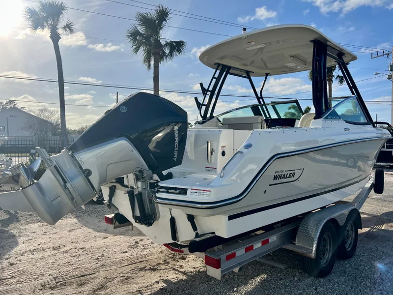Slide: The Image of 2025 Boston Whaler 240 Vantage boat on trailer, featuring a powerful Mercury outboard engine. - 7