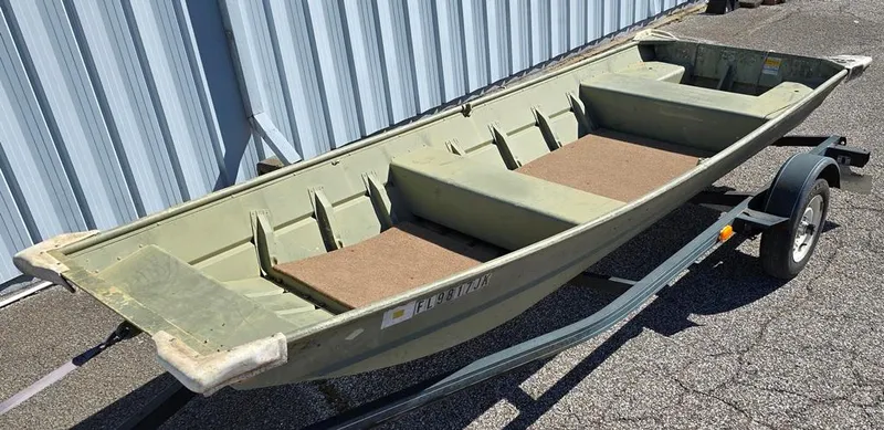 Slide: The Image of 1996 Sea Nymph Sport 1436 Jon boat on trailer, parked outdoors. - 0