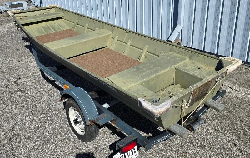 Slide: The Image of 1996 Sea Nymph Sport 1436 Jon boat on trailer, parked outdoors. - 1