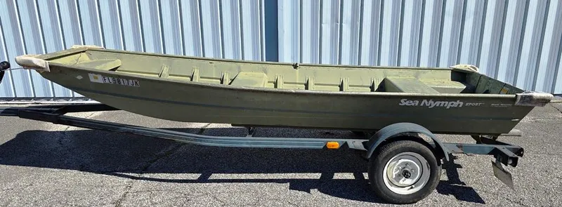 Slide: The Image of 1996 Sea Nymph Sport 1436 Jon boat on trailer, parked outdoors. - 4