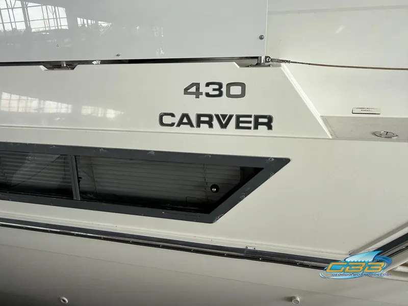 Slide: The Image of 1995 Carver 430 Cockpit Motor Yacht, side view with model name and logo. - 10