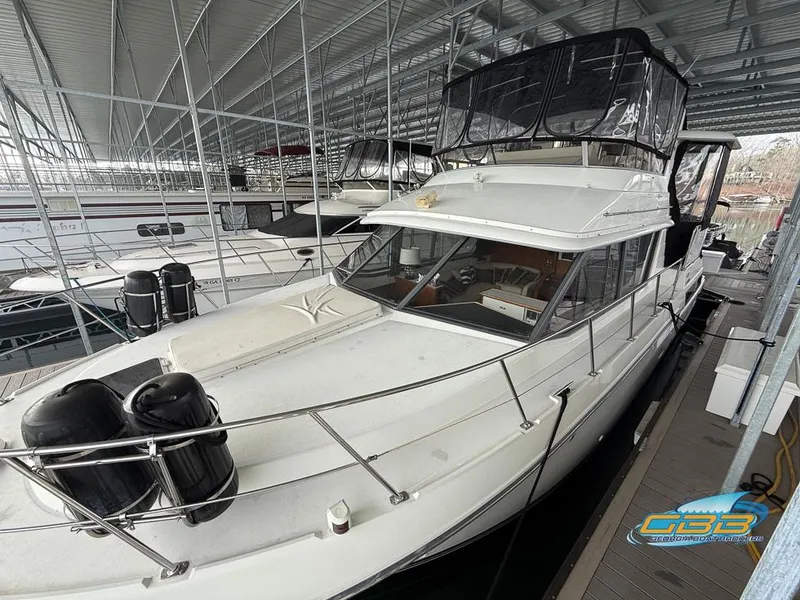 Slide: The Image of 1995 Carver 430 Cockpit Motor Yacht docked in a covered marina. - 11