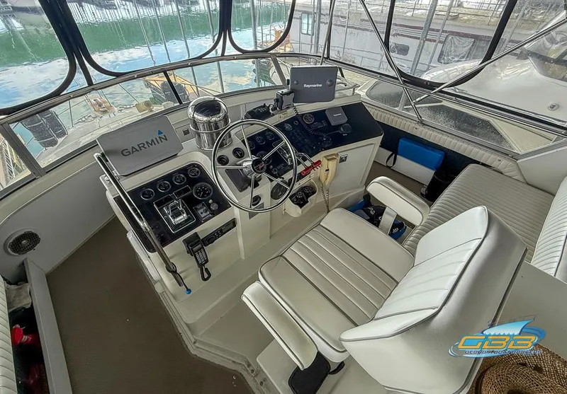 Slide: The Image of 1995 Carver 430 Cockpit Motor Yacht helm with Garmin navigation system and comfortable seating. - 13