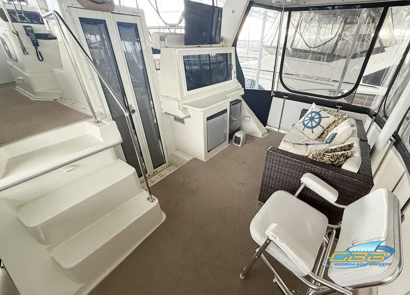 Slide: The Image of 1995 Carver 430 Cockpit Motor Yacht interior with seating, stairs, and nautical decor. - 16