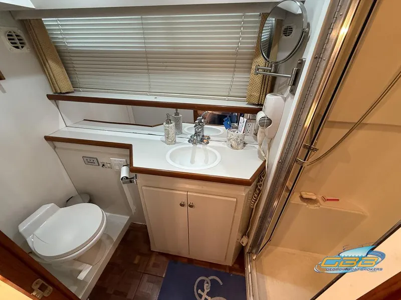 Slide: The Image of Bathroom of 1995 Carver 430 Cockpit Motor Yacht with sink, toilet, and shower. - 19
