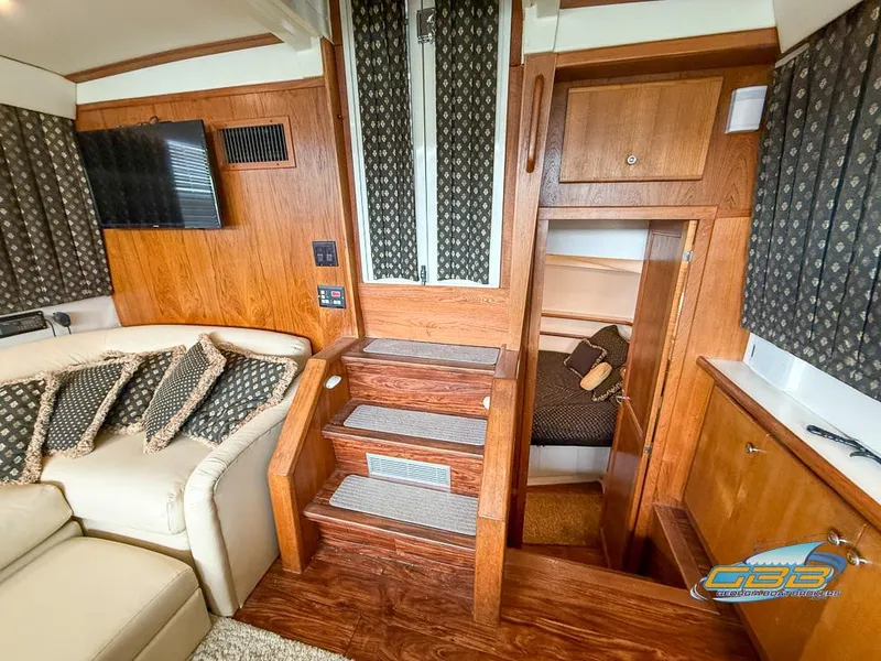 Slide: The Image of Interior of 1995 Carver 430 Cockpit Motor Yacht with wooden stairs and seating area. - 23