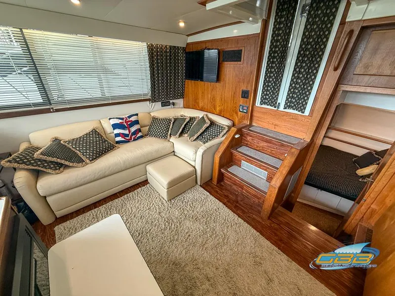 Slide: The Image of 1995 Carver 430 Cockpit Motor Yacht interior with cozy seating and wooden accents. - 24