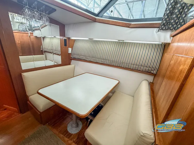 Slide: The Image of Interior of 1995 Carver 430 Cockpit Motor Yacht with dining area and seating. - 26
