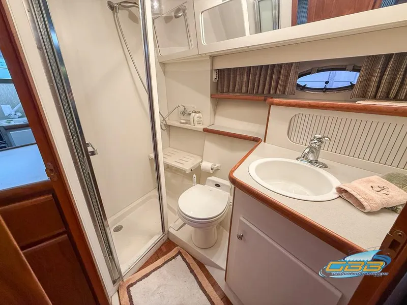 Slide: The Image of Bathroom interior of 1995 Carver 430 Cockpit Motor Yacht with shower, sink, and toilet. - 31