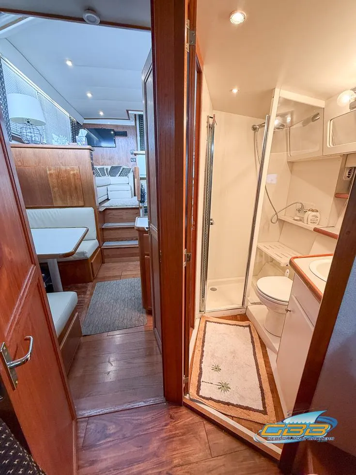 Slide: The Image of Interior of 1995 Carver 430 Cockpit Motor Yacht, featuring a cozy cabin and bathroom. - 32