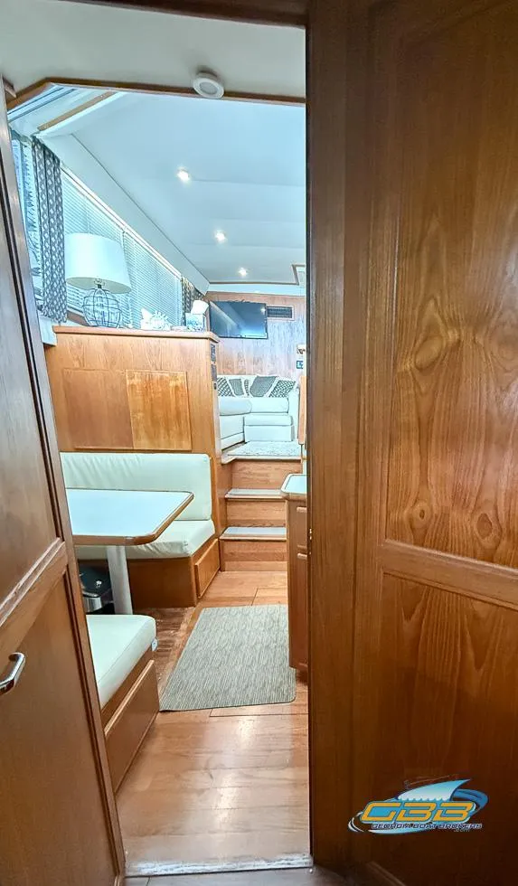 Slide: The Image of Interior view of 1995 Carver 430 Cockpit Motor Yacht, featuring wood paneling and seating area. - 33