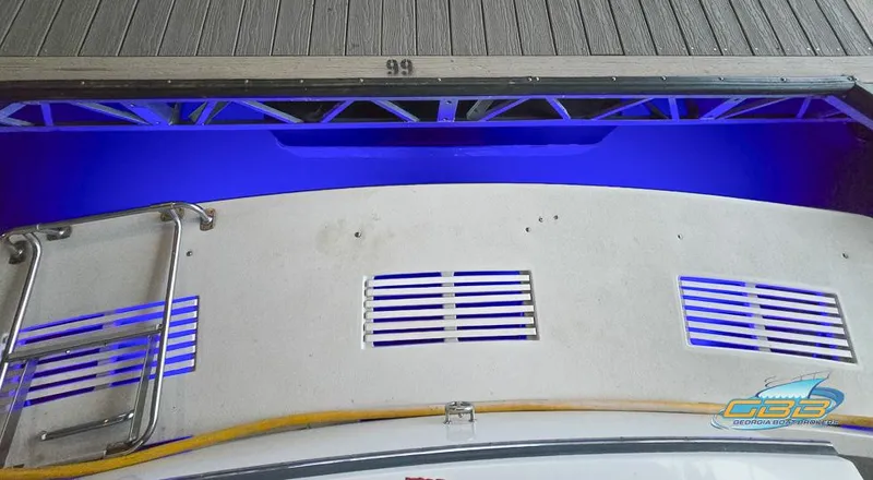 Slide: The Image of 1995 Carver 430 Cockpit Motor Yacht with blue underwater lighting at dock. - 37