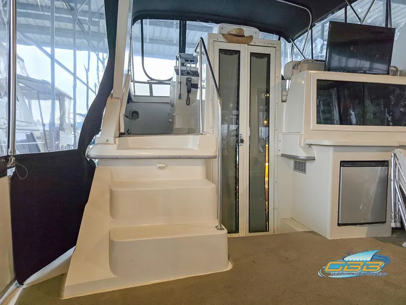 Slide: The Image of 1995 Carver 430 Cockpit Motor Yacht interior with stairs and glass doors. - 40