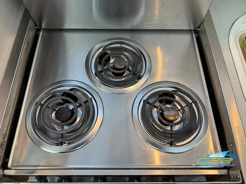 Slide: The Image of Stainless steel stove with three burners on a 1995 Carver 430 Cockpit Motor Yacht. - 43