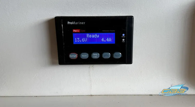 Slide: The Image of ProMariner control panel on 1995 Carver 430 Cockpit Motor Yacht, displaying voltage and current. - 47
