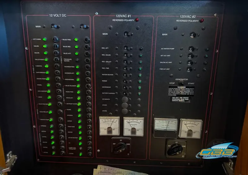 Slide: The Image of Electrical panel of a 1995 Carver 430 Cockpit Motor Yacht with various switches and indicators. - 49
