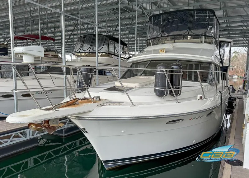 Slide: The Image of 1995 Carver 430 Cockpit Motor Yacht docked in a covered marina. - 6