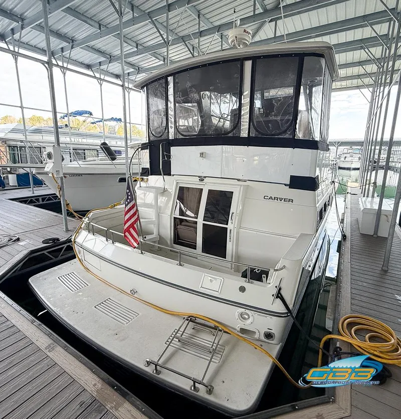 Slide: The Image of 1995 Carver 430 Cockpit Motor Yacht docked in a covered marina. - 7