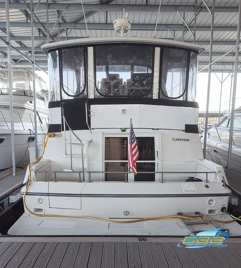 Slide: The Image of 1995 Carver 430 Cockpit Motor Yacht docked in a marina, rear view. - 8