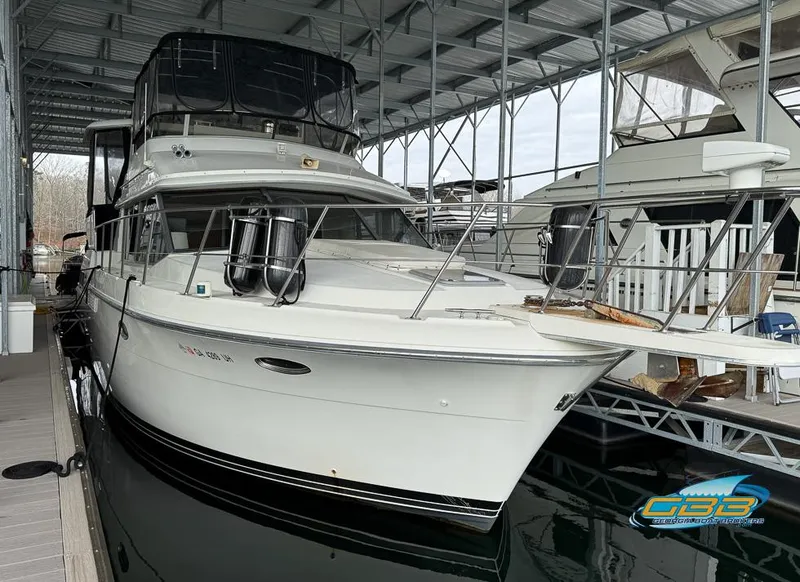 Slide: The Image of 1995 Carver 430 Cockpit Motor Yacht docked in a covered marina. - 9