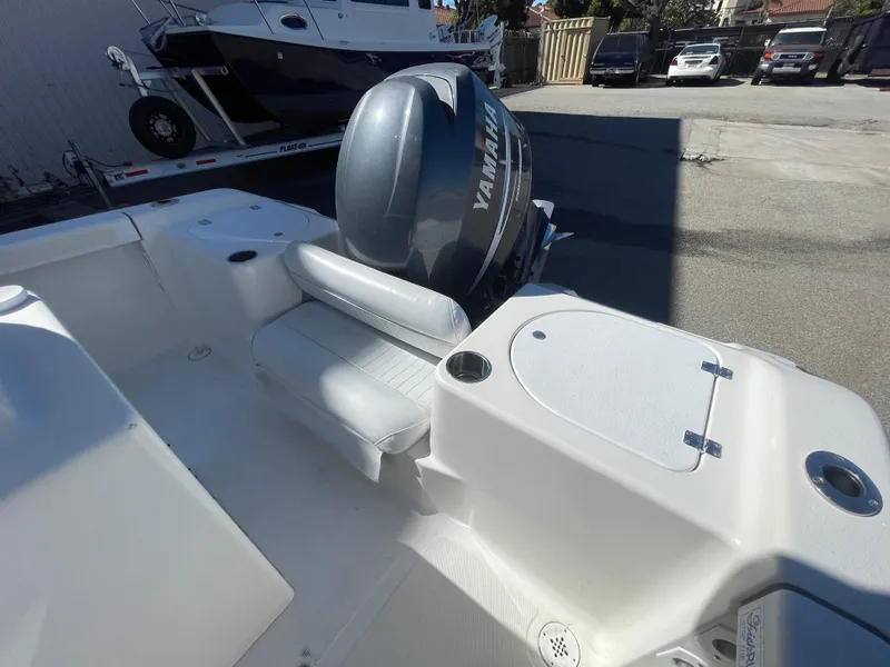 Slide: The Image of 2007 Tidewater 216 CC Adventure boat with Yamaha outboard motor, parked outdoors. - 21