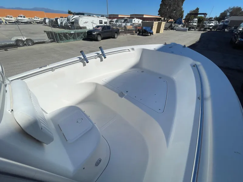 Slide: The Image of 2007 Tidewater 216 CC Adventure boat, spacious deck view, parked in a marina. - 25