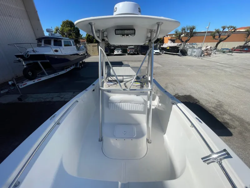 Slide: The Image of 2007 Tidewater 216 CC Adventure boat, white interior, parked outdoors. - 27