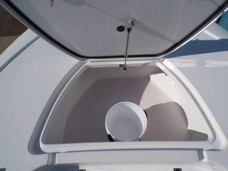 Slide: The Image of Open storage compartment on 2025 Tidewater 2410 BM boat, featuring a white bucket inside. - 16