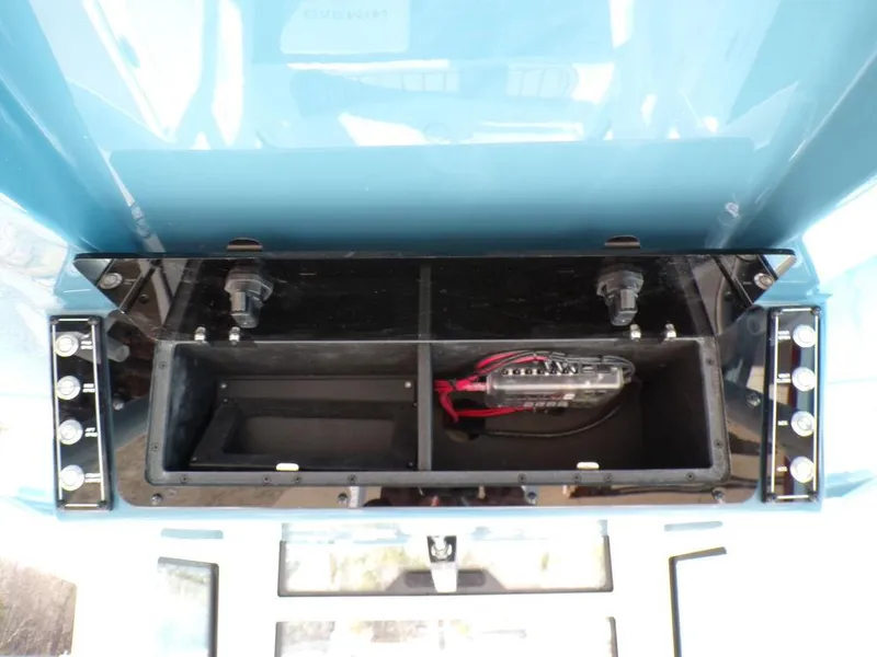 Slide: The Image of 2025 Tidewater 2410 BM boat storage compartment with wiring and connectors. - 29