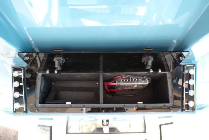 Slide: The Image of 2025 Tidewater 2410 Bay Max boat console with open storage compartment and wiring. - 30