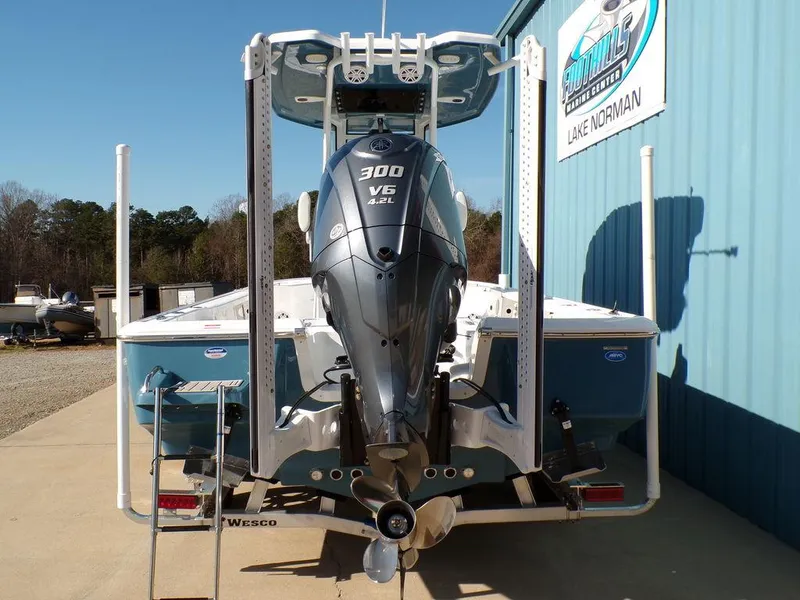 Slide: The Image of 2025 Tidewater 2410 BM boat with 300 V6 engine, parked outside a building. - 5