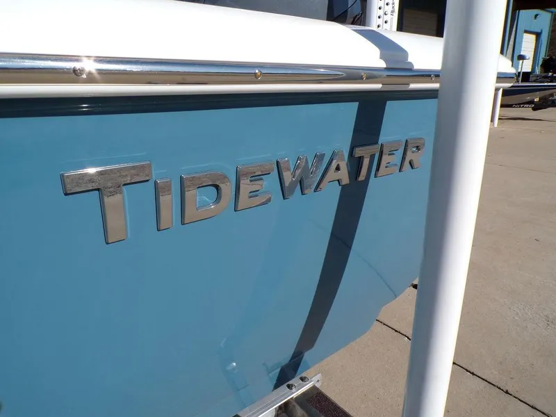 Slide: The Image of 2025 Tidewater 2410 BM boat with blue exterior and chrome lettering. - 7
