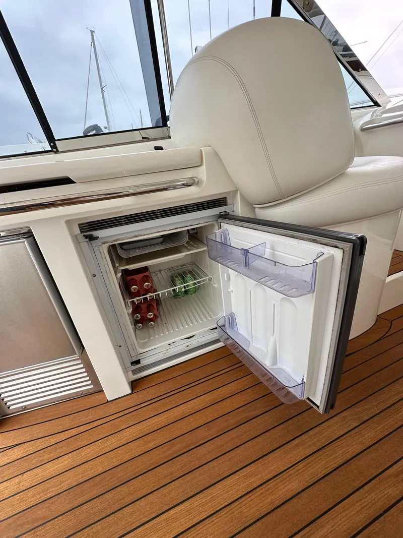 Slide: The Image of Open mini fridge on 2000 Sunseeker Predator 60 yacht, showcasing interior with drinks. - 36