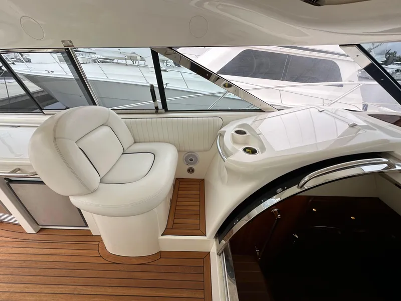 Slide: The Image of Luxurious interior of 2000 Sunseeker Predator 60 yacht with white seating and wooden flooring. - 48