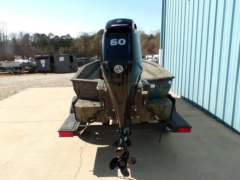Slide: The Image of 2025 Tracker Grizzly® 1650 T Prairie Wings Edition boat with Mercury 60 engine, parked outdoors. - 5